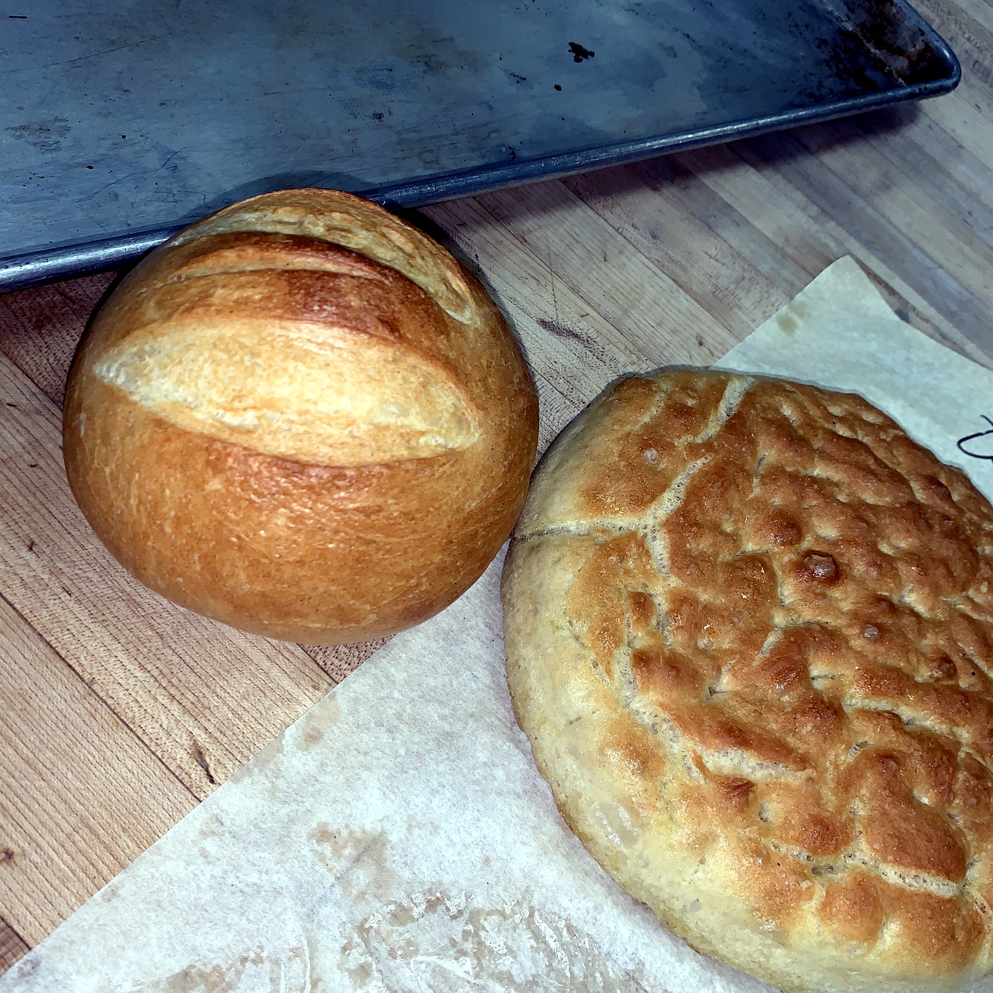 A scored sourdough boule with a golden crust